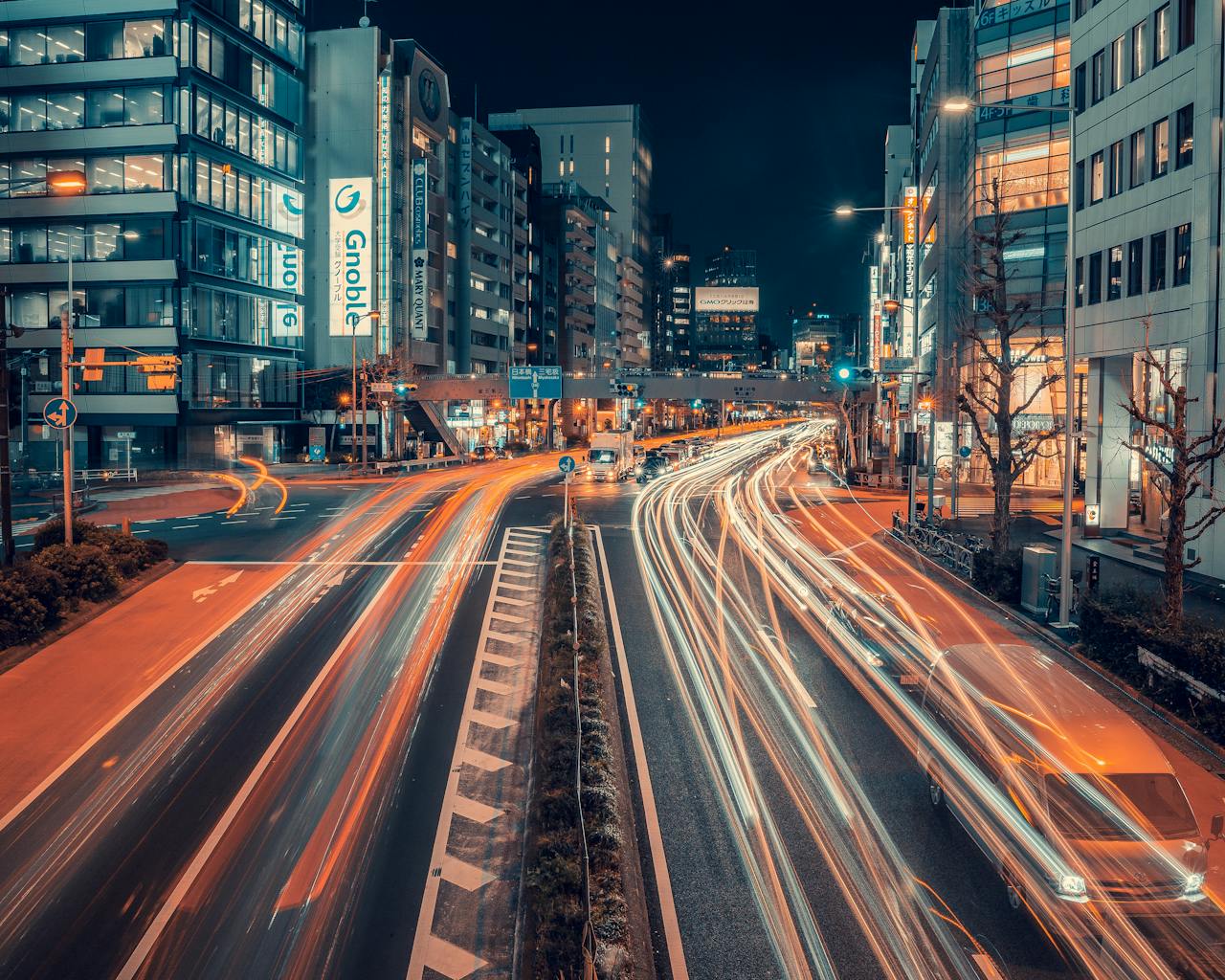 tokyo-night-traffic Dynamic long exposure of traffic in Tokyo, showcasing vibrant light trails and urban architecture.
